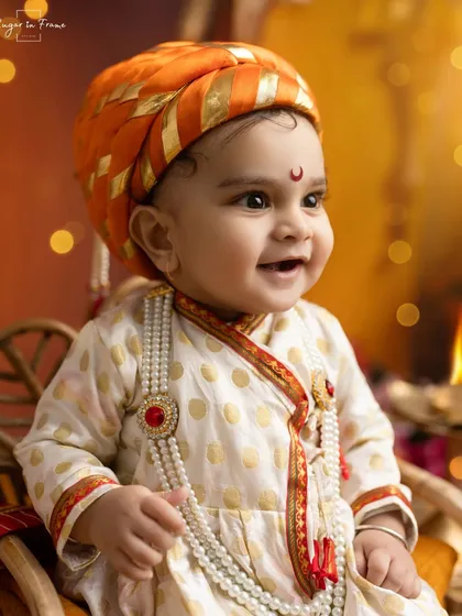 A close-up of our 'Bal Shivaji' looking absolutely adorable with a happy smile. We provide these detailed, authentic costumes for a truly special portrait.