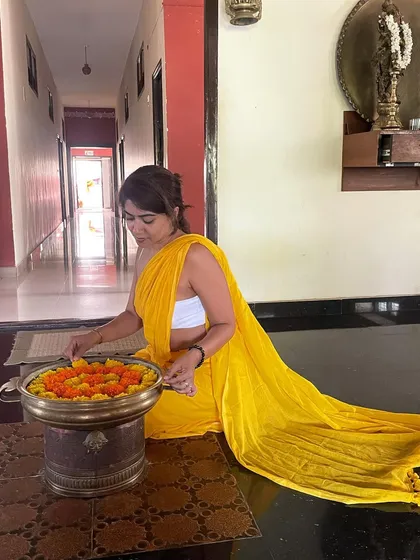 A moment of quiet gratitude, preparing a flower offering on my graduation day. Rituals like this are an important part of my practice, grounding me in devotion and the beauty of the present moment.