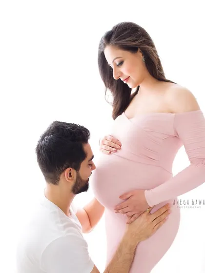 A classic pose where the father-to-be lovingly kisses the baby bump. It’s a beautiful way to symbolize his connection and excitement for the new arrival.