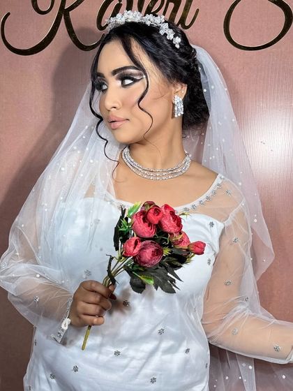A Christian bride holding a bouquet. The makeup is elegant and timeless, with a focus on classic beauty.