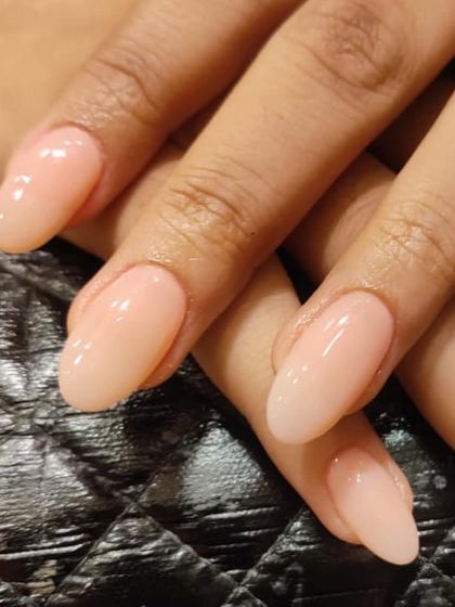 A close-up of these perfect nude extensions. The glossy finish and clean shape make them look so healthy and elegant.