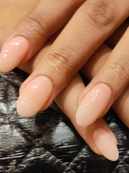 A close-up of these perfect nude extensions. The glossy finish and clean shape make them look so healthy and elegant.