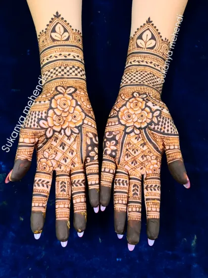 A classic and timeless full-hand design perfect for an engagement or wedding. The central floral motifs are surrounded by delicate patterns, creating a balanced and beautiful look.