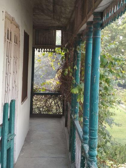 A section of the original balcony, showing the precarious condition of the timber and the urgent need for structural repair.