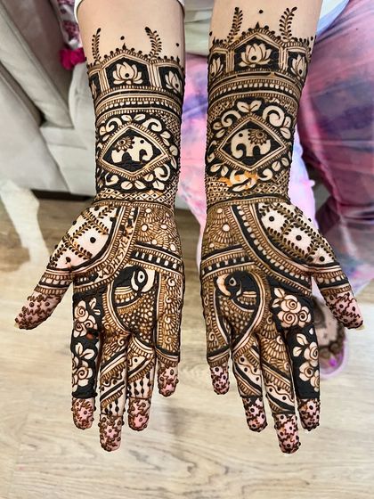 A mid-arm design featuring bold, contrasting patterns with elephants and lotuses.