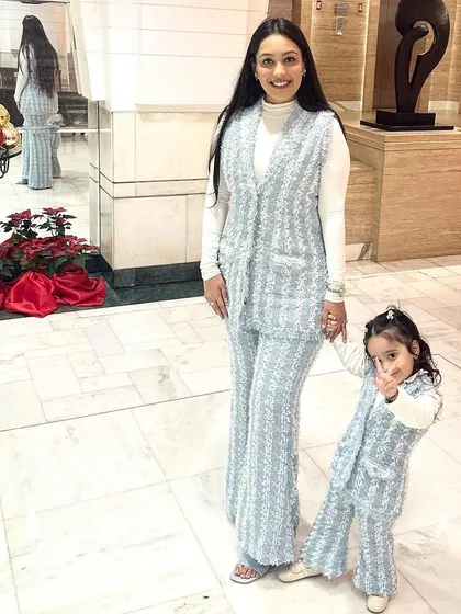 Twinning doesn't always have to be for ethnic occasions. I designed these chic, matching light blue tweed co-ord sets for myself and Aarriya for a stylish winter outing. The set includes a sleeveless vest and flared pants, perfect for layering.