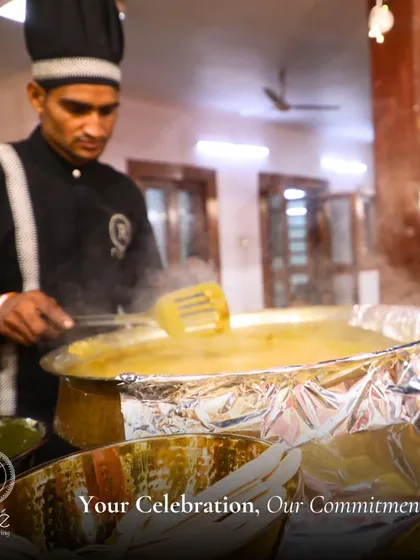 A chef stirs a large pot of dal or kadi at a live station. We cater to your every whim, from extravagant soirées to intimate gatherings, with the same level of commitment.