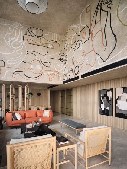 A wider view of the line-art mural, showing how it interacts with the room's architecture and the natural light from the large window.