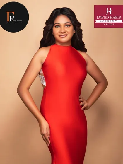 A model in a striking red gown, showcasing the professional level of styling our students provide for fashion shoots.