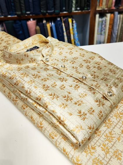 A classic beige kurta with a gold foil print, a subtle and elegant option for any festive occasion.