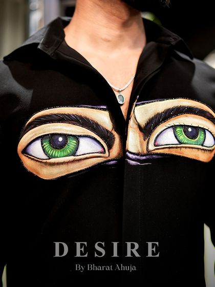 A detailed view of the hand-painted eyes on the 'Haters' shirt. The careful shading and highlights bring the design to life, creating a piece that truly stares back.
