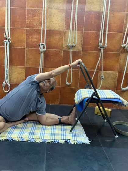 A seated forward bend with a chair.