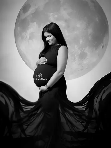 Another beautiful pose from my moon and stars series, captured in stunning black and white. This image highlights the mother's serene expression as she cradles her bump.