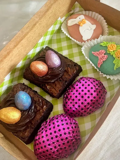 A peek inside one of my custom Easter hampers. This box is filled with a curated selection of my seasonal goodies, including egg nest brownies, hand-decorated marzipan eggs, and foil-wrapped chocolate eggs.