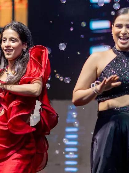 A candid shot of two performers laughing and dancing their hearts out on stage. These are the moments of pure joy that I love to capture.