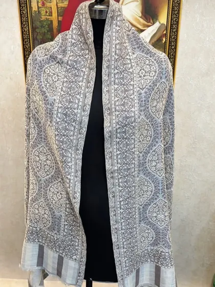 A full view of the light grey pashmina with the repeating floral pattern. It's a very delicate and feminine design.