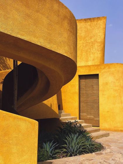 The spiral staircase is a central feature, its form both elegant and functional, leading to the upper suites.