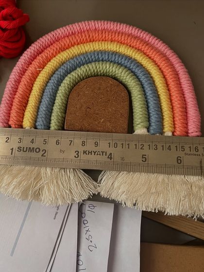 Here you can see one of my rainbow stencils being used to measure and guide the shape of a macramé rainbow. It takes all the guesswork out of the process, ensuring your final piece is perfectly proportioned.