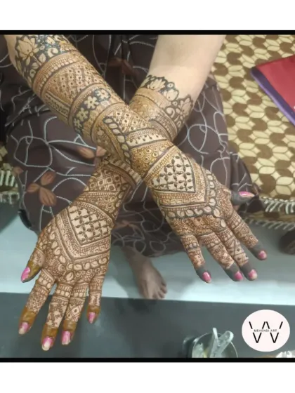 A full-arm design for the mother of the bride, showing her importance in the celebration.