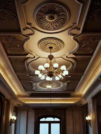 This is the ultimate in classic luxury. An ornate, coffered ceiling with intricate carvings, multiple medallions, and soft cove lighting that evokes the grandeur of a European palace.