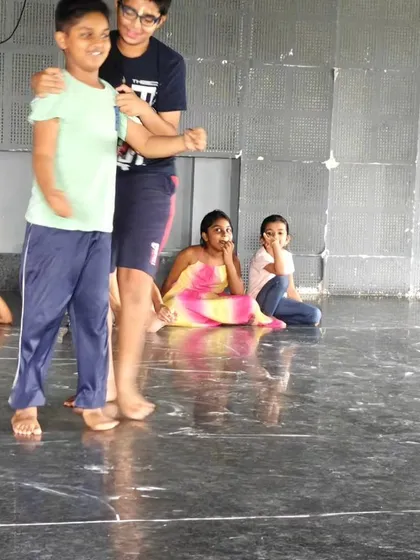 Two boys practicing a scene together during a rehearsal. Our workshops encourage collaboration and peer learning among the children.