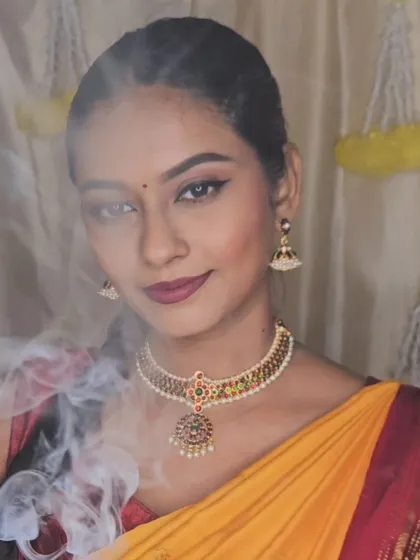 A dramatic shot with smoke for a Diwali-themed photoshoot. The makeup is bold and festive, creating a powerful image.