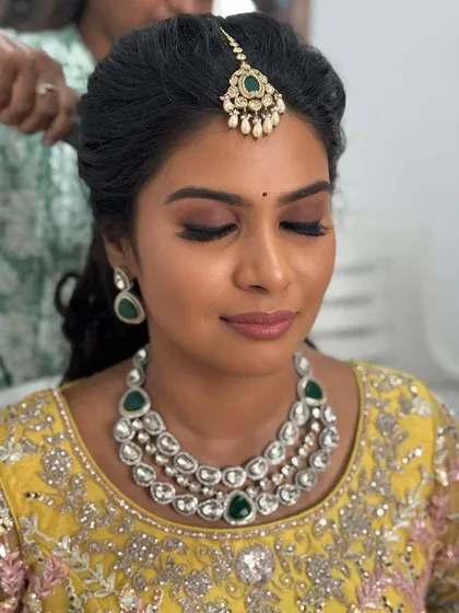 A close-up of my bride Abi's reception makeup with her eyes closed. The soft pink and brown eyeshadow creates a romantic and glamorous look.