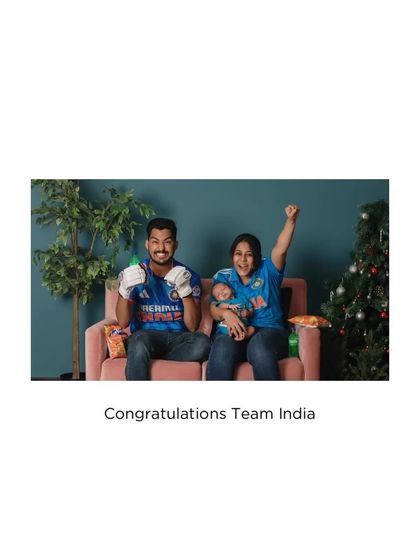 A family of cricket fans celebrating a win with their newborn.