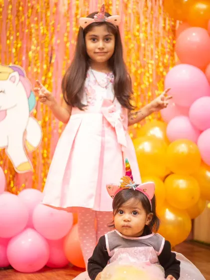 Princess alert! The birthday girl and her little sister posing in their unicorn headbands.