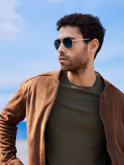 A classic, fashionable look for the Titan Eye+ campaign. I paired timeless aviator sunglasses with a suede bomber jacket and an olive green t-shirt for a cool, masculine style perfect for a beachside setting.