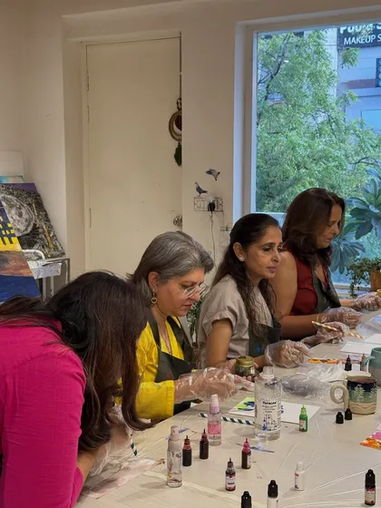 A group of friends enjoying an alcohol ink workshop together. It's a perfect activity for a fun and colorful get-together.