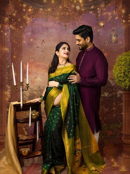 A romantic and intimate moment between a couple during their festive maternity session. The warm lighting and traditional outfits create a truly magical atmosphere.