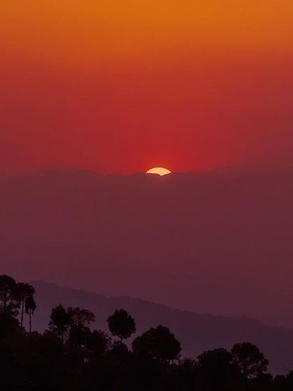 A deep red sunset over the rolling hills of Ranikhet. I love capturing these moments when the sky feels heavy with color, just before the day ends.