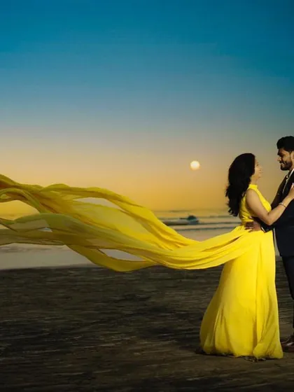Another stunning example of our yellow flying gown, this time against a beautiful sunset. The flowing fabric creates incredible movement, making for dynamic and romantic pre-wedding photos.
