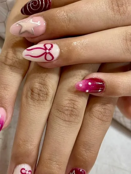 A fun and festive set with a mix of hand-painted designs, including stars, bows, and polka dots in a pink and red color scheme.