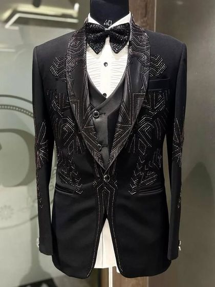 A still image of the three-piece tuxedo with intricate geometric embroidery, a true statement of bespoke luxury.