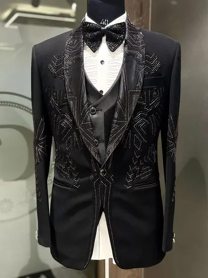 A full view of the black three-piece tuxedo with geometric embroidery. The waistcoat and jacket are perfectly coordinated to create a cohesive and striking look for any formal event.