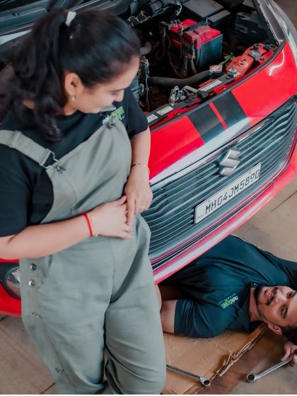 A candid moment of interaction during the garage shoot. This photo captures the couple's playful dynamic and the unconventional, cool vibe of the theme.
