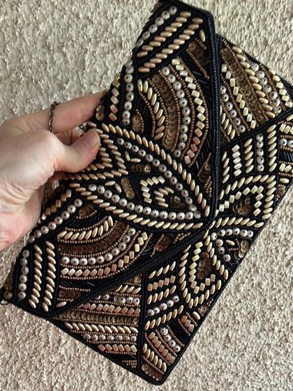 A close-up of the beaded clutch I sourced for the masquerade ball look. The intricate beadwork complemented the gown's design perfectly.