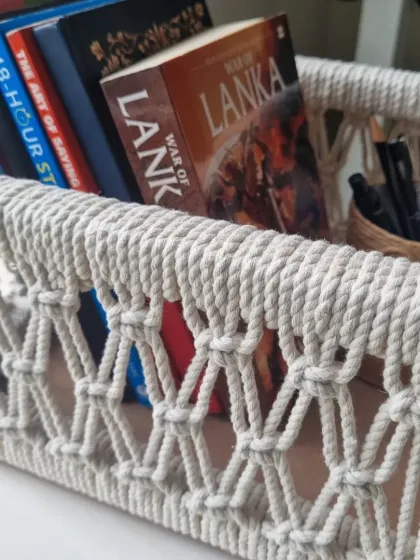 My multipurpose macrame baskets are where function meets beauty. This one, shown here holding books, is built on a sturdy wooden frame, making it perfect for organizing your essentials or creating a beautiful, personalized gift hamper.