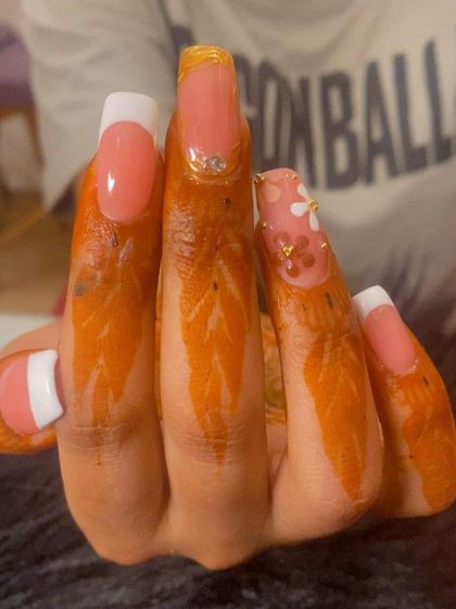 Another angle showing the combination of French tips and intricate nail art.