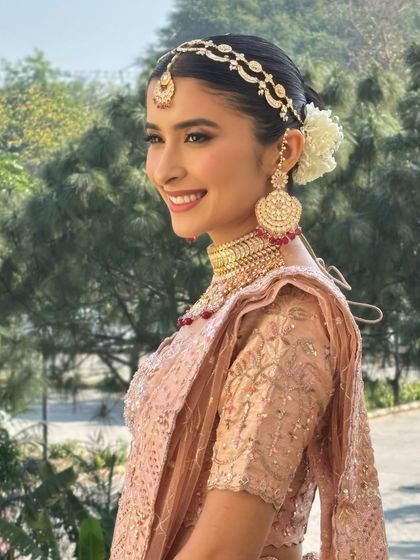 Aarushi was a vision in her pastel pink lehenga for her day wedding. We kept the makeup fresh and radiant, with a clean winged liner and a soft pink lip. These portraits capture the look from every beautiful angle.