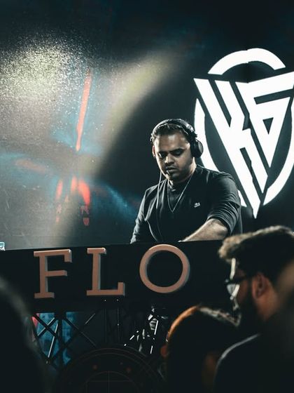 A focused shot of me at the FLO console, with my logo glowing on the screen behind me.