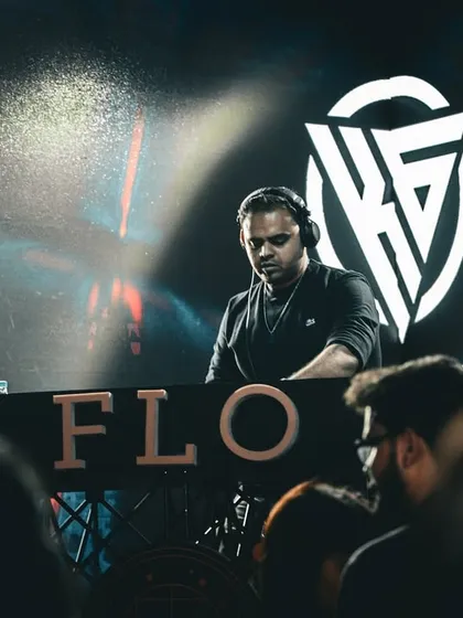 A focused shot of me at the FLO console, with my logo glowing on the screen behind me.
