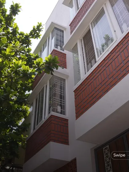 A low-angle view of the bay windows, which are designed to capture light and create cozy seating nooks within the bedrooms.