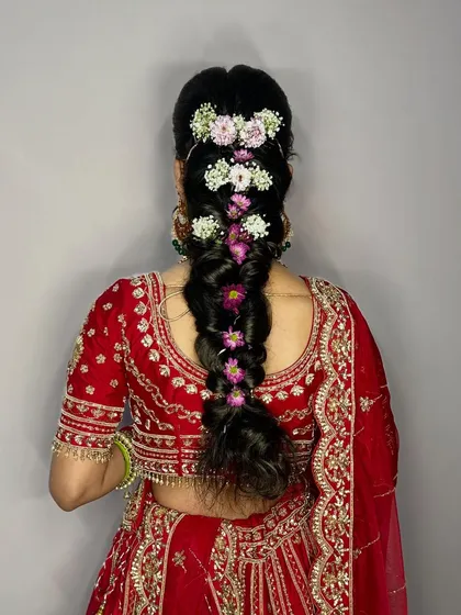A bridal look is incomplete without the perfect hairstyle. I love creating these intricate braids with fresh flowers to add that traditional and elegant touch.