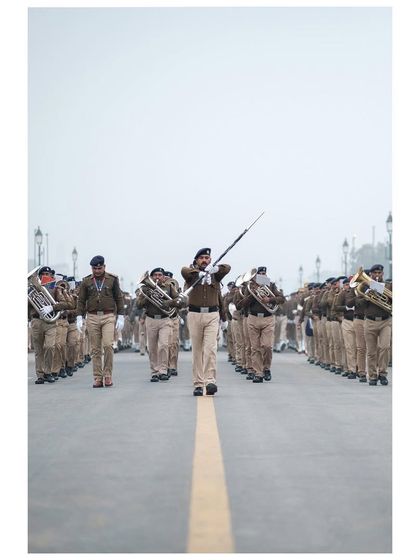 A band conductor leads his contingent down the Kartavya Path during a misty morning rehearsal.