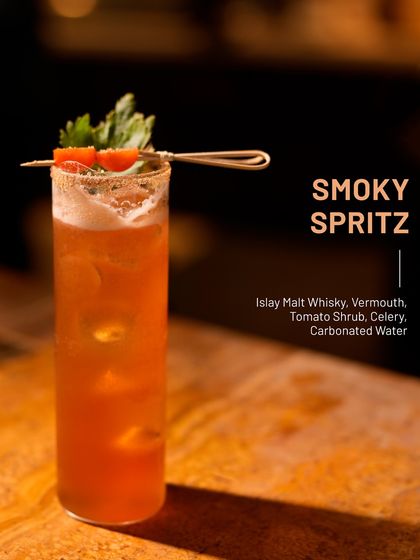 The Smoky Spritz, a bold twist on a highball. It blends Islay malt whisky, vermouth, and a tangy tomato shrub for a drink that's fresh, earthy, and crisp.