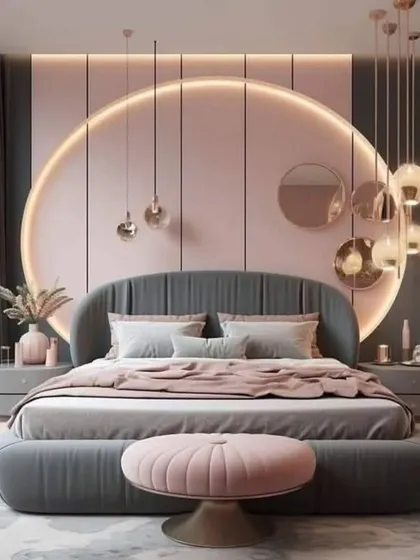 A glamorous bedroom with a circular pink accent wall and a grey tufted bed. The cluster of metallic pendant lights adds a touch of sparkle and sophistication.