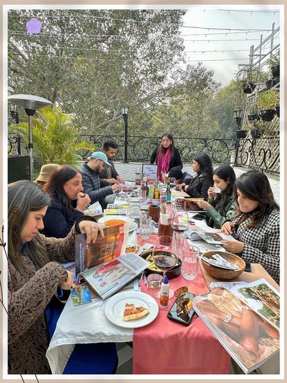 A wider view of our Sunday workshop. A full table of people, each on their own journey but sharing the same space and positive energy. This is what community and collective creation looks like.
